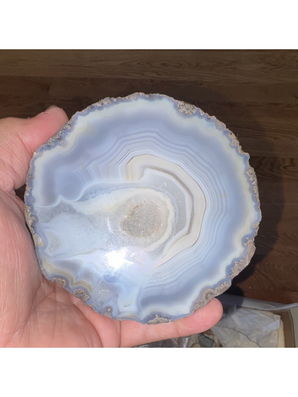 agate geode slice, specifically a blue and white variety with a quartz crystal